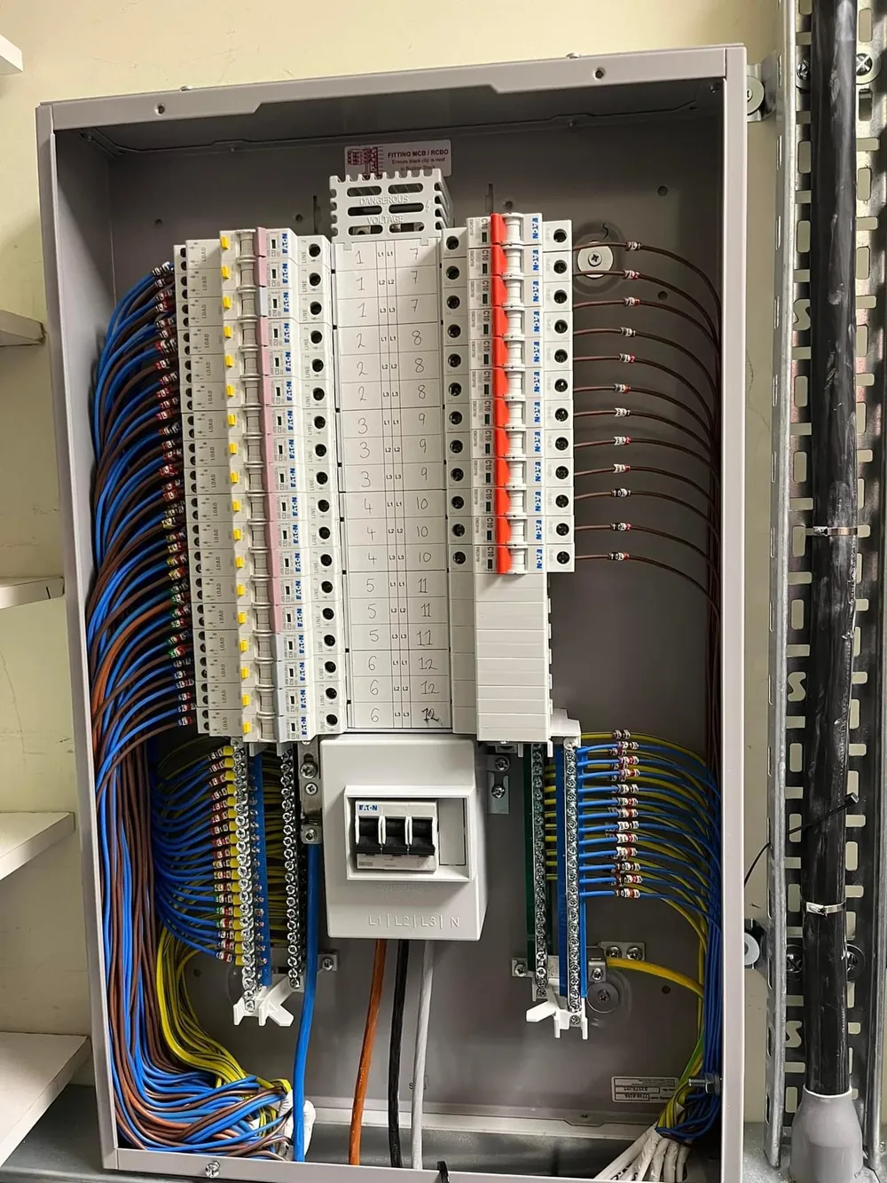 Three-phase distribution board fully labelled and loomed by DTF Electrical during a commercial installation in Merseyside
